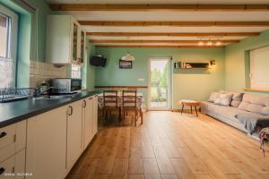 a kitchen and living room with a couch and a table at U Jana i Wita in Istebna