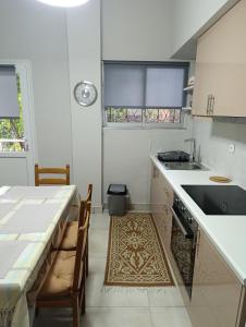a kitchen with a table and a sink and a table at The Lemon House in Káto Loutrón +5 photos