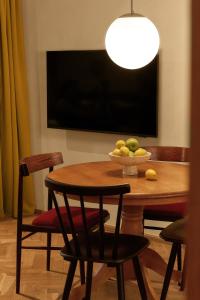a dining room table with a bowl of fruit on it at NELIS I Boutique Apartments in Old Town in Prague