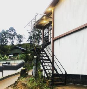a staircase on the side of a building at Birdwing Cottage, Munnar in Munnar