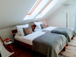 two beds in a room with a attic at Villa WoW in Zastań