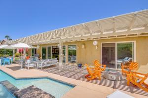 a house with a swimming pool with chairs and a patio at Private Pool and Mtn Views Luxe Palm Springs Home! in Palm Springs