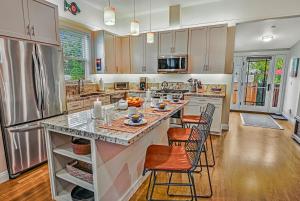 a large kitchen with a large island with bar stools at Downtown Villa by Paradise Retreats in Santa Barbara