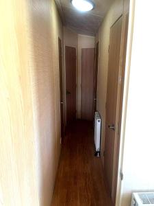 an empty hallway with a room with a door and a hallway at Spacious 8-Berth Caravan at Unity Beach Resort in Brean +22 photos