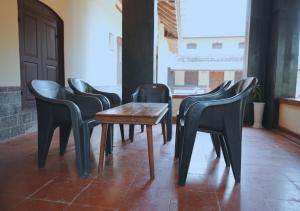 a group of chairs and a table in a room at Vintage Vista in Lakkidi