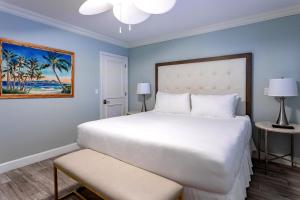 a large white bed in a room with blue walls at Crane's Beach House Boutique Hotel & Luxury Villas in Delray Beach +77 photos