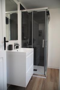 a bathroom with a white sink and a shower at Hulu 2 in Savona +10 photos