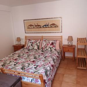 ein Bett in einem Schlafzimmer mit zwei Nachttischen und zwei Tischen in der Unterkunft Sweet Life in Costa Del Silencio