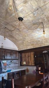 a kitchen with a wooden table and a ceiling at Domus Pacinus in Pacentro