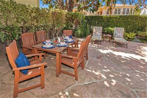 a wooden table and chairs with a tea set on it at Juniper Cottage by Paradise Retreats in Santa Barbara