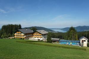 a large building on top of a green field at Ferienhotel Hofer superior in Strass im Attergau