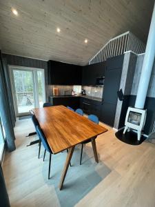 a kitchen with a wooden table and chairs in a room at Modern chalet in Malangen in Mestervik