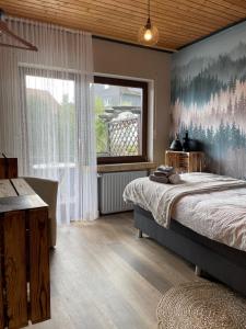 a bedroom with a large bed and a large window at Waldhof Hochsauerland in Medebach