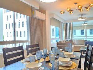 a dining room with a table and chairs and a couch at Charming Apartment on the Cinta Costera N#5 in Panama City