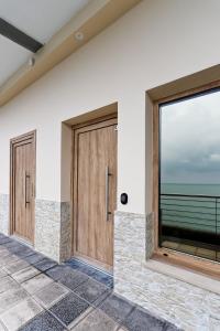 a row of wooden doors on a building at Confort y calma junto al mar, vistas a Gaztatape in Getaria