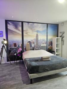 a bedroom with a large window with a city view at 1988 NEW YORK Baignoire ilot et video projecteur in Seyssinet-Pariset +2 photos