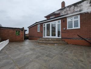 a brick house with a patio in front of it at 2 Ensuite Bedroom House Near Centre Free Parking in York