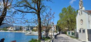 a church next to a river next to a building at Studio Dream 30m od plaze in Đenovići +14 photos