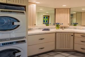 a laundry room with a washer and dryer at Ocean Breeze Bungalow by Paradise Retreats in Summerland