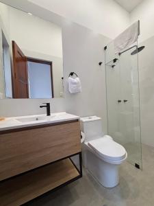 a bathroom with a toilet and a sink and a shower at Sori Apartments in Lima +28 photos