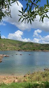 a large body of water with rocks in it at Rancho Velho Chico in Canindé de São Francisco