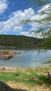 a large body of water with rocks in it at Rancho Velho Chico in Canindé de São Francisco