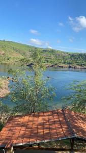 a view of a body of water with a wooden deck at Rancho Velho Chico in Canindé de São Francisco