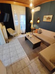 a living room with a couch and a coffee table at HARBOR house in Kavála