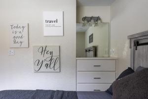 a bedroom with a bed and a dresser and a mirror at Air Haus LITE in Fourth Crossing +25 photos