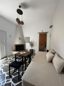 a bedroom with a bed and a desk and a table at Lithari Traditional Apartment in Agios Sostis