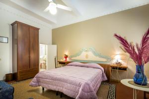 a bedroom with a bed and a table with a vase at Hotel Ferretti in Florence
