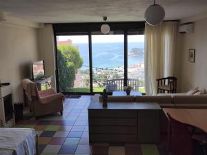 a living room with a couch and a large window at AEGEAN view ! in Kavála