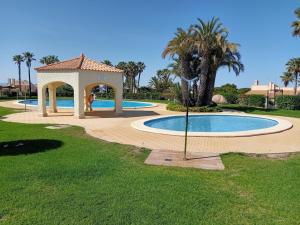 a swimming pool with a gazebo in a yard at Between the sky and the sea in Alicante