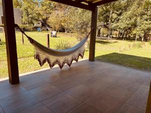 a hammock on a porch with a view of a park at Casa rural in Rivera
