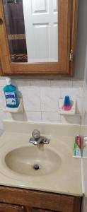 a bathroom counter with a sink and a mirror at Happiness queen room 3 in Newark +8 photos