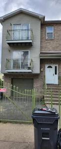 a house with a trash can in front of it at Happiness queen room 3 in Newark