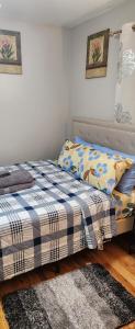 a bedroom with two beds and a rug at Happiness queen room 3 in Newark