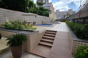 a patio with stairs and plants and a pool at Ed. Delta Gardenn in Carmo