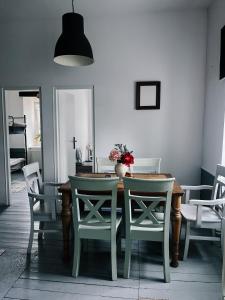 a dining room with a wooden table and chairs at Sowa Loft in Zagórze Śląskie