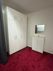 an empty room with white cabinets and a mirror at Sissi Suite in center of Vienna in Vienna