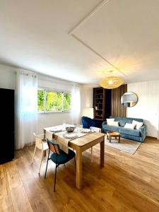 a living room with a table and a couch at Bleu Saline - Plage 250m in La Saline les Bains +28 photos