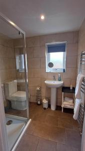 a bathroom with a shower and a sink and a toilet at Garden Apartment Morpeth- with lockable bike storage! in Morpeth +23 photos