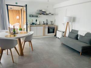 a living room with a table and a couch at La planque du raton laveur in Lierneux