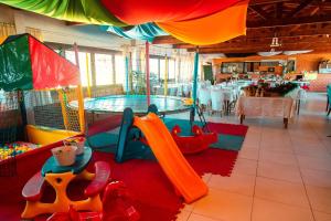 a childrens play area with a slide and a playground at Oceano Hotel in Torres