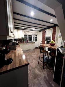 a kitchen with a blue and white striped ceiling at Cheerful Four Bedroom Cottage with Spacious Garden in Besthorpe