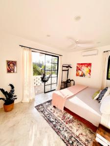 a bedroom with a bed and a large window at King Bed, Kitchen, Saltwater Pool, Fast Wifi, Air Conditioning - Flor at Casa Calavera in San Francisco
