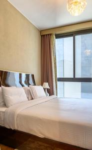 Postel nebo postele na pokoji v ubytování VESTA - El Sheikh Zayed Residence