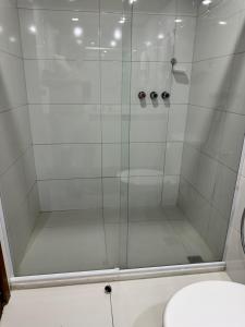 a shower with a glass door in a bathroom at Flat Privativo Sol Victoria Marina in Salvador