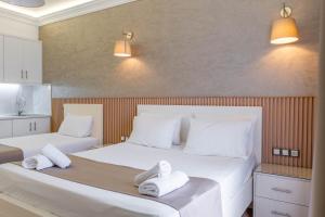 two beds in a room with white towels on them at Hotel Mira Mare in Ksamil