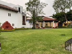 a yard of a house with a grass field at Casa Rosales in Antigua Guatemala